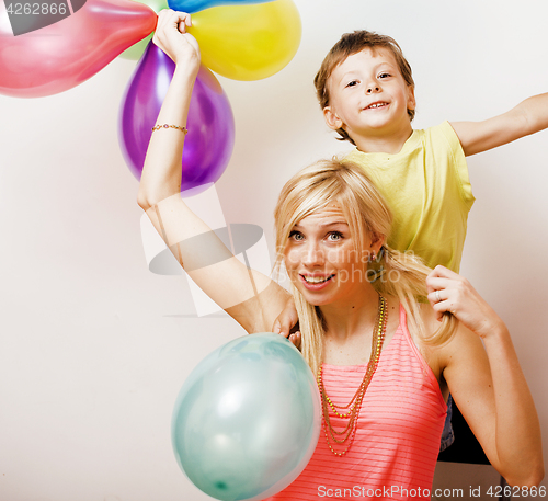 Image of pretty real family with color balloons on white background, blon