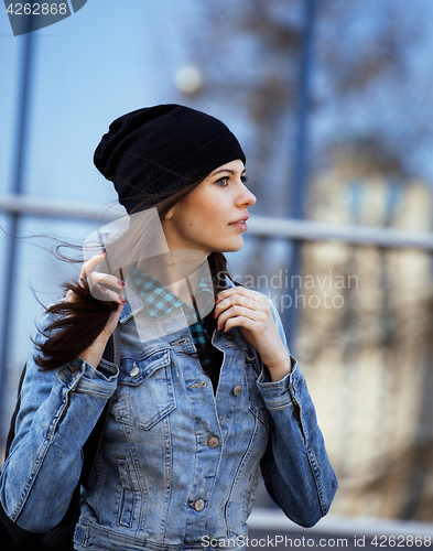 Image of young pretty girl near business building walking