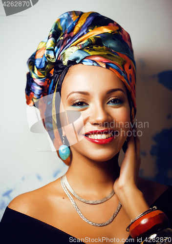 Image of beauty bright african woman with creative make up, shawl on head