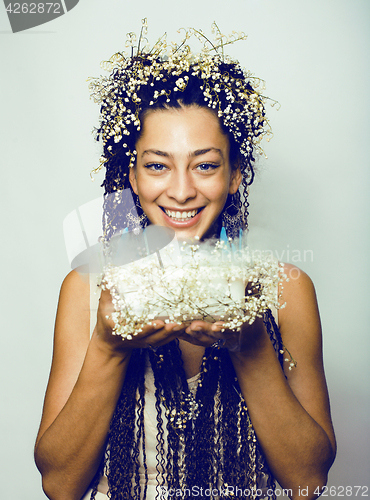 Image of young pretty brunette girl with bouquet of little white spring f