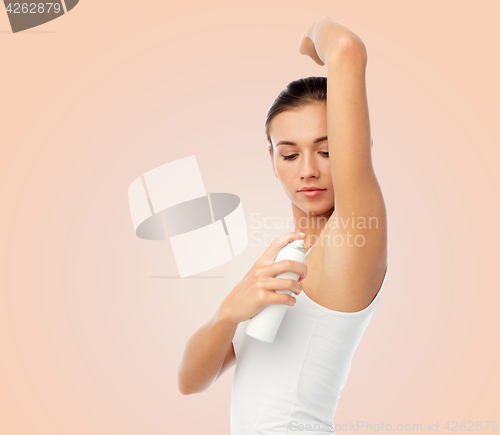 Image of woman with antiperspirant deodorant over white