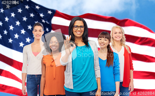 Image of international american happy women showing ok