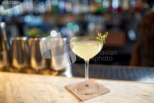 Image of glass of cocktail at bar