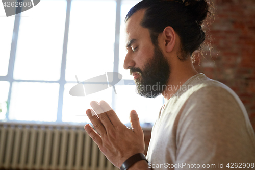 Image of close up of man meditating at yoga studio