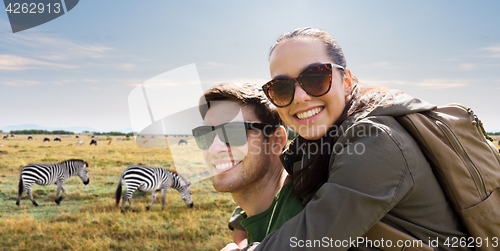 Image of smiling couple with backpacks traveling in africa