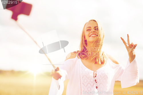 Image of happy young woman taking selfie by smartphone