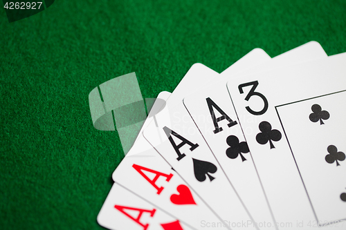 Image of poker hand of playing cards on green casino cloth