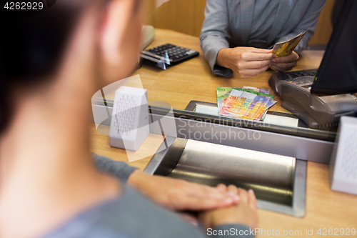 Image of clerk counting cash money at bank office