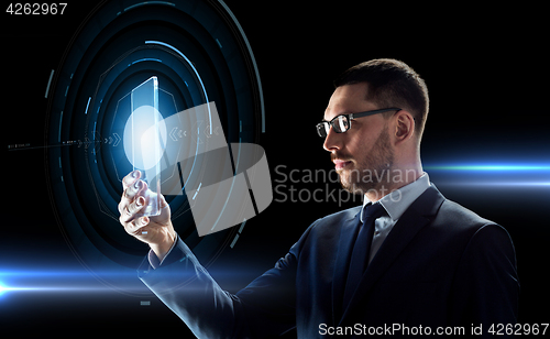 Image of businessman working with transparent tablet pc