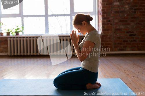 Image of close up of woman meditating at yoga studio