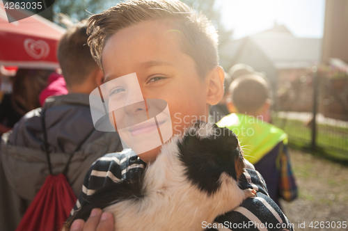 Image of happy smiling boy with cavy