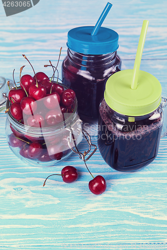 Image of Cherry juice with glass of berries