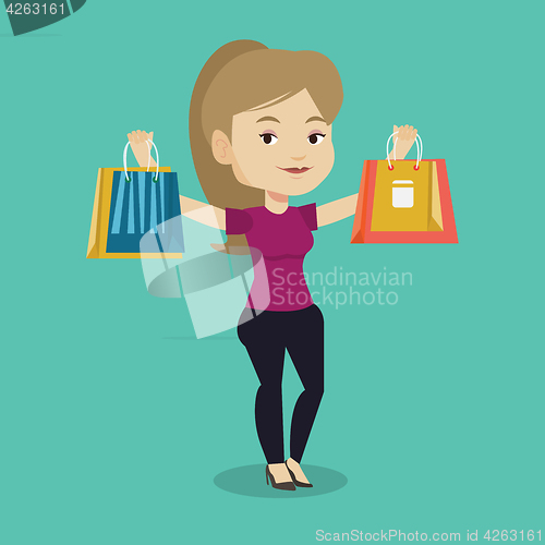 Image of Happy woman holding shopping bags.