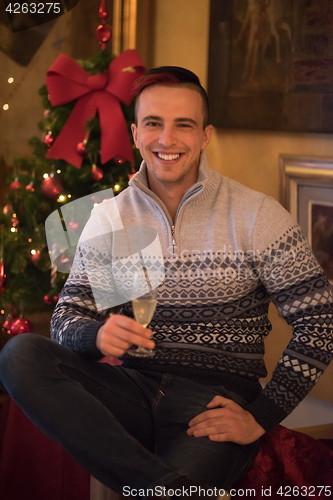 Image of Happy young man with a glass of champagne