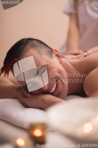 Image of young man having a back massage