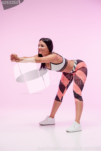 Image of The woman training against pink studio