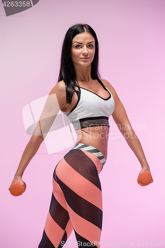 Image of The woman training against pink studio