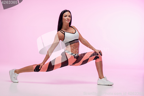Image of The woman training against pink studio