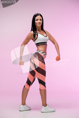 Image of The woman training against pink studio