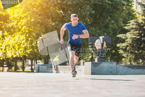 Image of Man running in park at morning. Healthy lifestyle concept