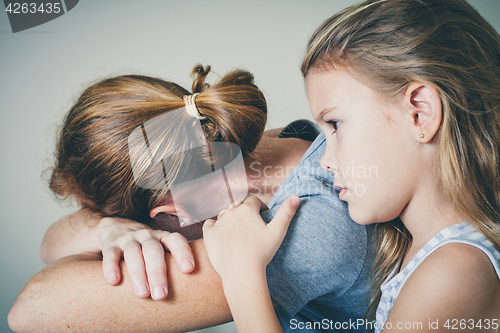 Image of sad daughter hugging his mother