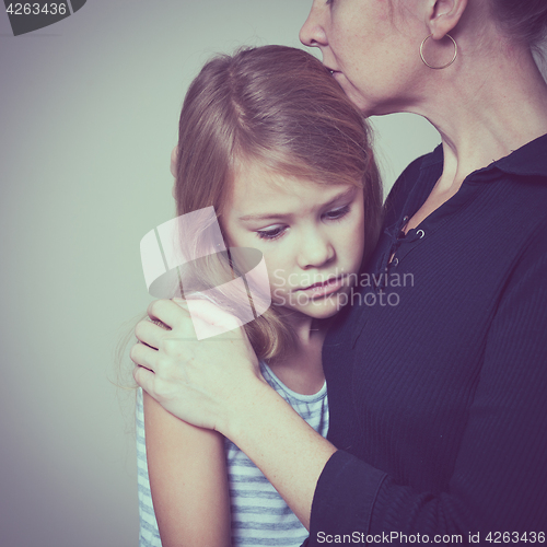 Image of sad daughter hugging his mother