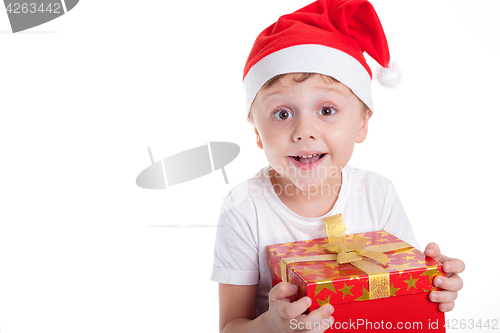 Image of Happy little smiling boy with christmas gift box.