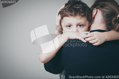 Image of sad son hugging his mother