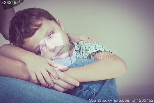 Image of sad son hugging his mother