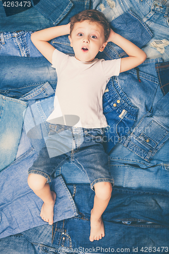 Image of Cute little boy  the background jeans.