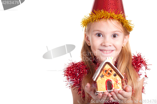 Image of Happy little smiling girl with christmas house. 