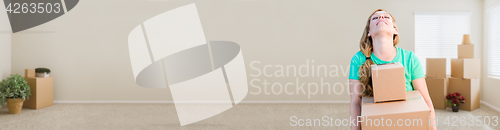 Image of Banner of Tired Young Adult Woman Holding Moving Boxes In Empty 