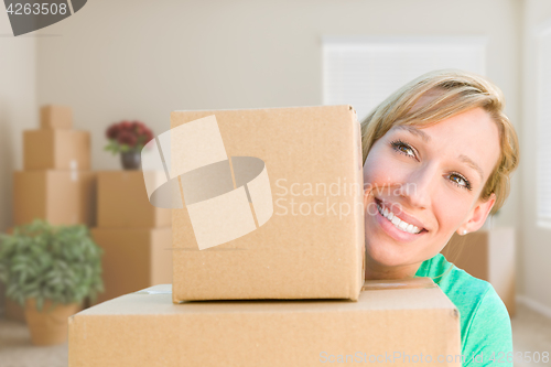 Image of Happy Young Adult Woman Holding Moving Boxes In Empty Room In A 