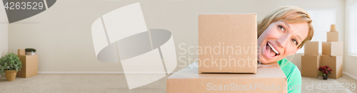 Image of Banner of Happy Young Adult Woman Holding Moving Boxes In Empty 