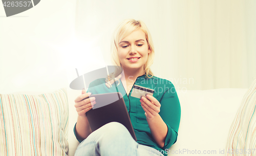 Image of happy woman with tablet pc and credit card