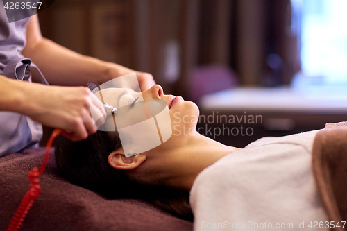 Image of woman having hydradermie facial treatment in spa