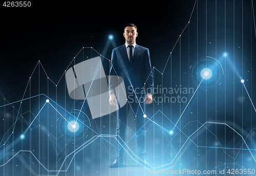 Image of businessman in suit over black with virtual graph