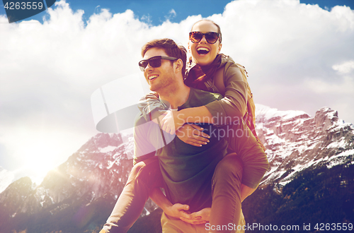 Image of happy couple with backpacks traveling in highlands