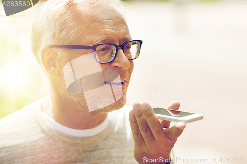 Image of old man using voice command recorder on smartphone