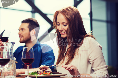 Image of happy couple having dinner at restaurant