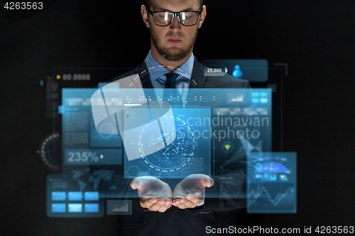 Image of businessman with virtual screens over black