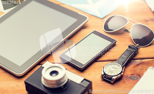 Image of close up of smartphone and travel stuff