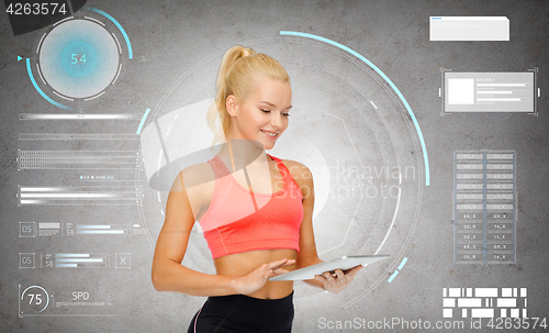 Image of happy sporty woman with tablet pc computer