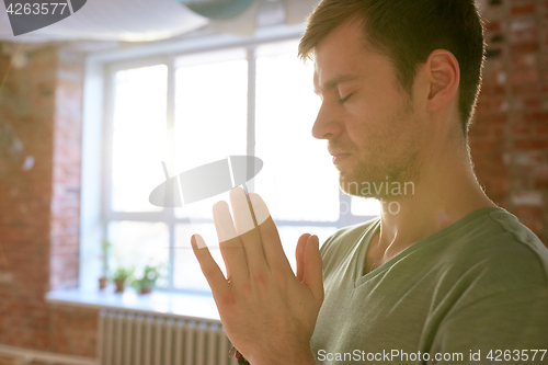 Image of close up of man meditating at yoga studio