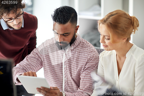 Image of business team with tablet pc computer in office