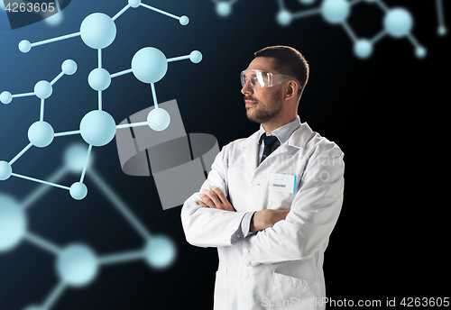Image of scientist in lab coat and goggles with molecules