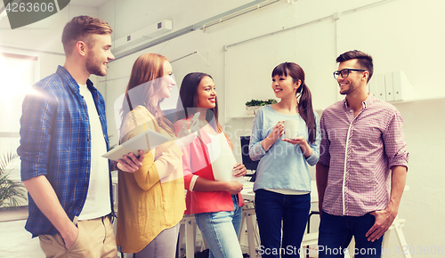 Image of creative team on coffee break talking at office