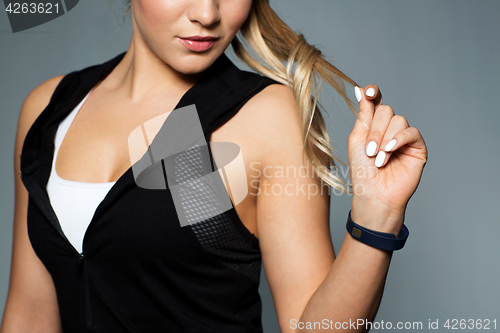 Image of close up of sporty woman with fitness tracker