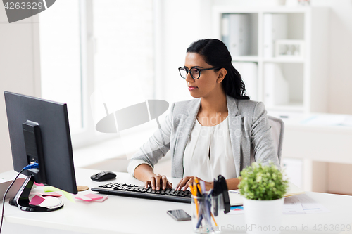 Image of businesswoman with computer working at office