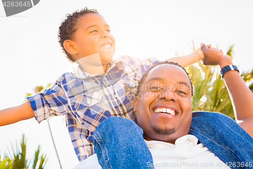 Image of Mixed Race Son and African American Father Playing Piggyback Out